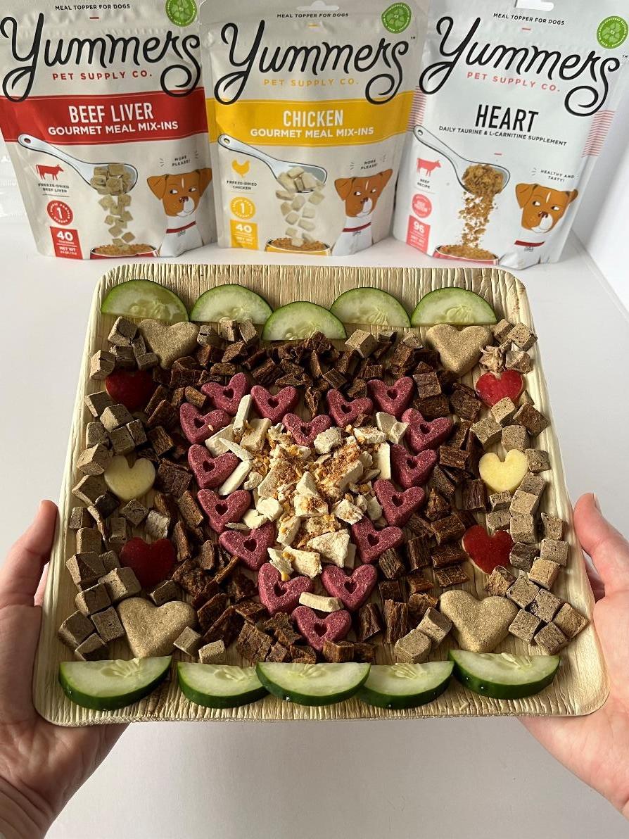 A barkuterie board with a Valentine's love theme featuring Yummers products
